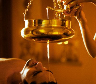 06 Oct 2004, Cansaulim, India --- Man receiving Shirodhara treatment at Sereno Spa at Park Hyatt Goa in India. Shirodhara is an Ayurvedic technique of pouring warm oil slowly onto the center of the forehead. --- Image by © Luca Tettoni/Corbis